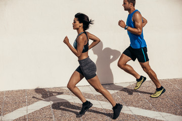 Two runners running outdoors in morning