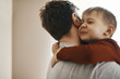 © Westend61 - Portrait of toddler hugging his father