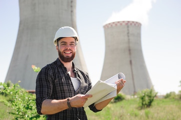 Wall Mural - Portrait of an architect builder, serious civil engineer working with documents on construction site.