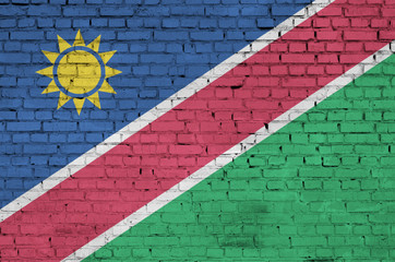 Namibia flag is painted onto an old brick wall