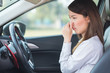 © structuresxx - Young woman holding her nose because of bad smell in car.
