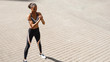 © Artem Varnitsin - Muscular sportswoman standing in city with hands in front of her chest, preparing for exercising