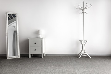 Wall Mural - bright home interior with white cupboard and coat rack and gray floor and free copy space for your d