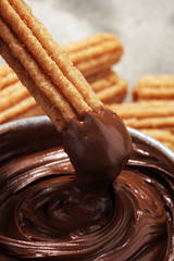 Traditional Spanish dessert churros with sugar and chocolate