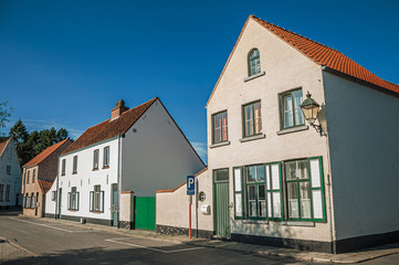 Wall Mural - Facade of old brick houses on an empty street, in the late afternoon light at Damme. A quiet and charming countryside old village near Bruges. Northwestern Belgium.