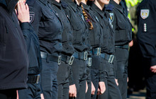 Female Police Officers In Black Uniform Standing In A Row