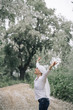 © karrastock - woman with white headscarf in the forest, has cancer