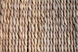 Background texture of beige or straw colored wicker or seagrass