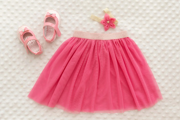 Concept of children's clothing, fashionable children's clothes, fashion. Skirt with flower headband, shoes for girl.