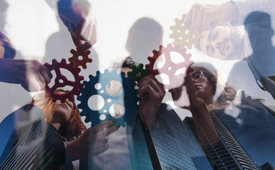 Business team connect pieces of gears. Teamwork, partnership and integration concept. double exposure