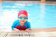 © kornnphoto - Asian children cute or kid girl wear swimming suit and goggles on swimming pool and smile with happy fun in water park for learning and training or refreshing and relax with exercise on summer holiday