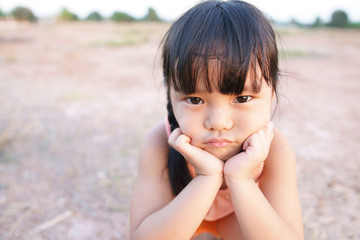 asian children cute or unhappy kid girl and country child poor with make face frown and angry or sad