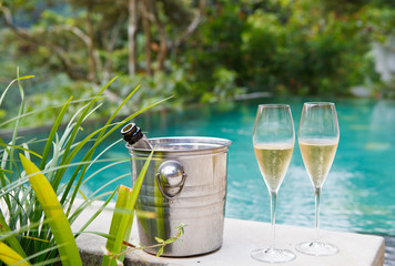 glasses of champagne near tropic pool