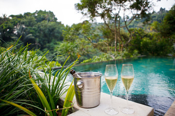 glasses of champagne near pool