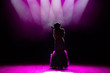 © nagaets - Silhouette of singer on stage. Dark background, smoke, spotlights