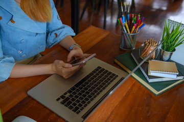 Business women use technology to communicate in the workplace, such as phones and notebooks, to grow their businesses rapidly.