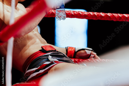 Fotografía MMA fighter in red corner of ring break between rounds