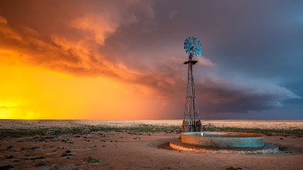 Wall Mural - Windmill in a Thunderstorm at Sunset