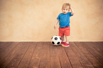 Wall Mural - Child is pretending to be a soccer player