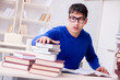 © Elnur - Male student preparing for exams in college library