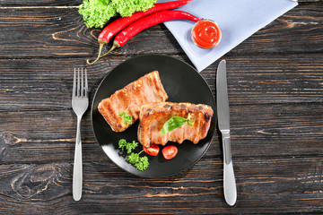 Sticker - Plate with delicious grilled ribs on wooden table