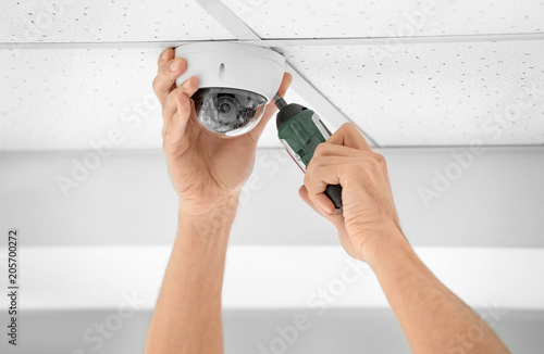 Technician Installing Cctv Camera On Ceiling Indoors Closeup