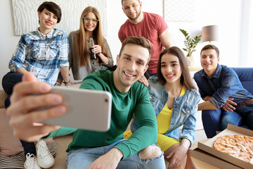 Wall Mural - Happy friends taking selfie indoors