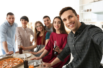 Wall Mural - Happy friends taking selfie indoors