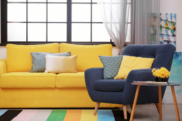 Poster - modern room interior with comfortable sofa and rainbow carpet