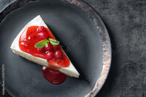 Fotografering  Delicious cheesecake served with sweet jam on plate, top view