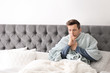 © New Africa - Sick young man with cough suffering from cold in bed