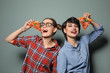© New Africa - Attractive young women with slices of delicious pizza on color background