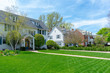 Traditional suburban homes with green front lawns