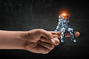 Wall Mural - spaceman on finger. mixed media