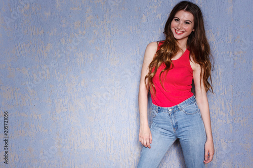 Beautiful Long Haired Girl In Jeans And A Pink T Shirt Posing