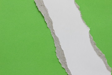 ripped note paper on green background