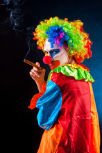 Mad Clown On Black Background. Woman Smoking Cigar. Portrait Of Crazy Female. Scary Clowns Falling Victim To Vigilante Violence As Terrified Residents. People Who Hate Their Work. Suit For Halloween.