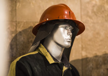 Exhibition Firefighter Dummy In Fire Fighter Helmet And Uniform. Protective Rescue Wear. Head Light Torch
