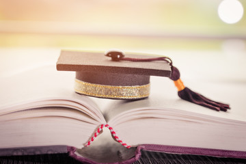 Graduation cap on Books in Library room of campus and university, Concept of knowledge Graduate abroad international Educational, Back to School