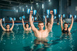 © Nomad_Soul - Aqua aerobics group, exercise with dumbbells