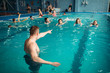 © Nomad_Soul - Instructor works with class in swimming pool
