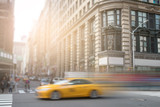 Fototapeta Miasta - New York City yellow taxi speeding through Manhattan street