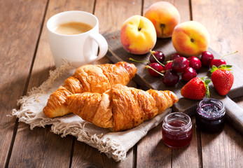 breakfast with croissants, coffee and fresh fruits