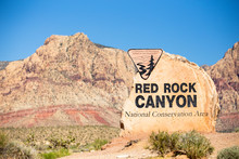 Rock Boulder Sign For Red Rock Canyon In Las Vegas Nevada With Mountains In The Background