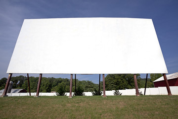 Wall Mural - Rural drive-in screen against blue sky.