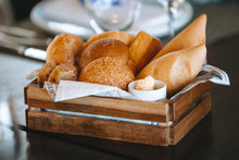 Buns In A Wooden Bread Box On A Table With A White Tablecloth In A Cozy Restaurant Before A Dinner Party.