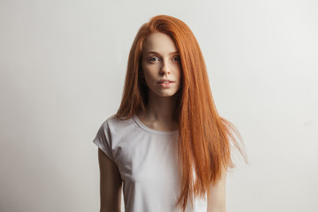 Wall Mural - Portrait of a cheerful young ginger woman with beautiful long hair after using new Hair care product