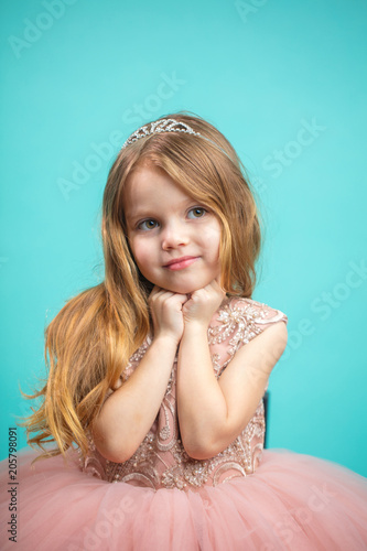 Studio Portrait Of Lovely Blue Eyed 4 Year Old Girl With Tiara On
