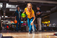 Young Woman Throwing Bowling Ball