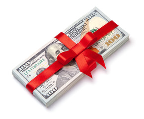 Concept, money as gift, win or bonus. Pile of 100 dollar bills is tied with red ribbon with bow. Isolated on white background.